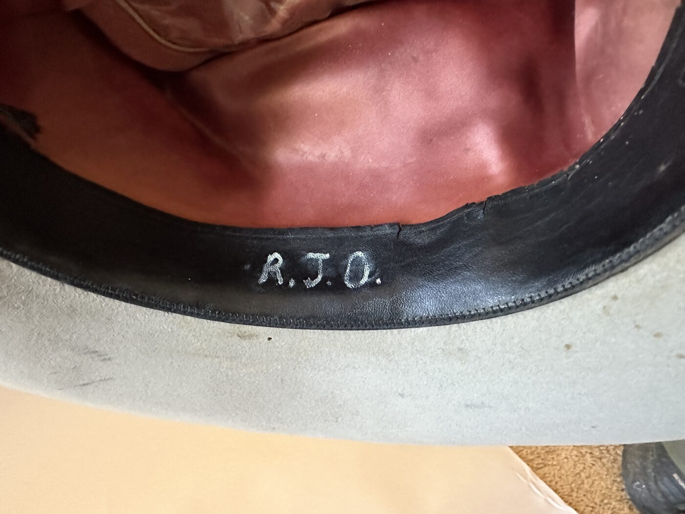 The initials R.J.O. handwritten inside the hat's sweatband